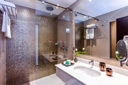 a bathroom with a sink and a shower at Amadil Ocean Club in Agadir