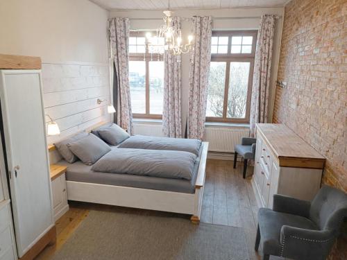 a bedroom with a bed and a desk and window at Bauernhaus Premium in Fehmarn