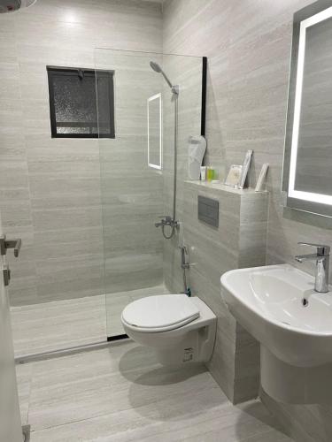 a bathroom with a shower and a toilet and a sink at ريڨا للأجنحة السكنية Riva suites in Irbid