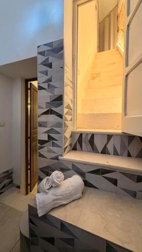 a bathroom with two towels on a counter at Lumia - Casa Vacanze in Martina Franca