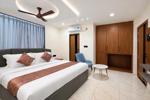 a bedroom with a bed and a table and a chair at Planet Eco Stays - Near Mahakal Temple in Ujjain