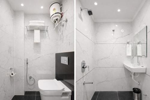 a bathroom with a shower and a toilet and a sink at Planet Eco Stays - Near Mahakal Temple in Ujjain