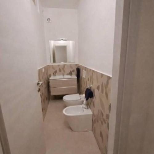 a small bathroom with a toilet and a sink at Casa Margherita in Castelfidardo