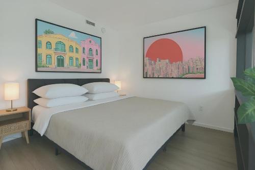 a bedroom with a large white bed with two pillows at Cadenza Miami - Luxury Residences in Miami