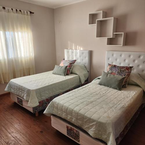 a bedroom with two beds and a window at Duplex Parking free in Estación Circunvalación