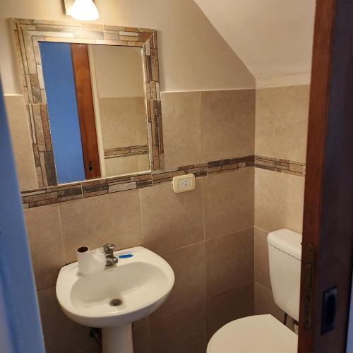 a bathroom with a sink and a toilet and a mirror at Duplex Parking free in Estación Circunvalación