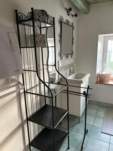 a black shelf in a bathroom with a sink at Gîte la Chenevière in Étueffont