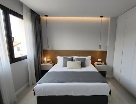a bedroom with a large bed and a window at Apartamentos Arinaga Ocean View in Arinaga
