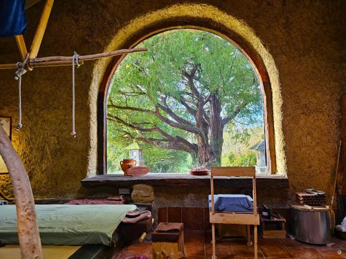 an arched window in a room with a tree at Hotel Restaurante Casa Petronila in Taramundi