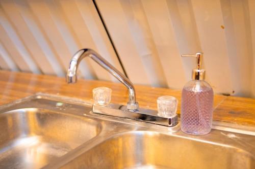 a kitchen sink with a bottle of soap on it at Casa Monte Bello- Cabaña privada in Huehuetenango