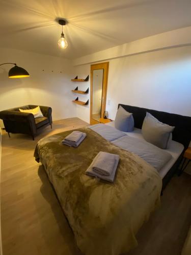 a bedroom with a large bed with towels on it at Forrest Lounge Schweina in Bad Liebenstein