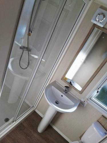 a bathroom with a sink and a shower at My Spacious Kentish 3-Room Van in Birchington