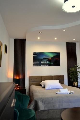 a bedroom with a bed and a couch and a table at Apartament Piast w Rynku in Nysa