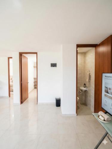 a white room with a toilet and a sink at Pilarica Gardens in Medellín
