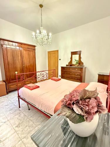 a bedroom with a bed with a bowl of flowers on a table at House of Arcadia in Pistoia