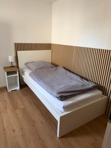 a bedroom with a bed with a wooden headboard at Tuvalu in Remagen