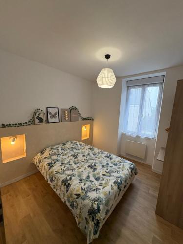 a bedroom with a bed with a floral bedspread at Petite rivière in Nantes