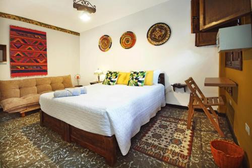 a bedroom with a bed and a couch at Casa Ruta Sur in Cali