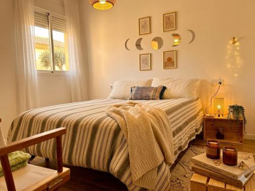 a bedroom with a bed with a blanket on it at Apartamento Gades Conil C in Conil de la Frontera