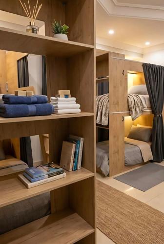 a room with wooden shelves with beds and books at Your Home In Riyadh Hostel in Riyadh