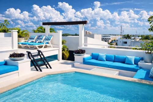 a patio with a swimming pool and lounge chairs at Mansion Mauresque in Playa del Carmen