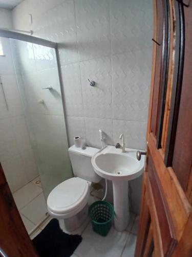 a small bathroom with a toilet and a sink at Pousada JC 50 in Santarém