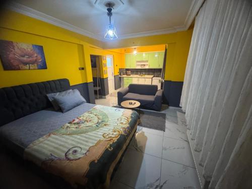 a bedroom with a bed and a living room at İlkadım Suit Apart in Samsun
