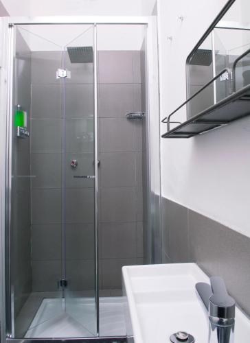 a glass shower in a bathroom with a sink at La Pergola with Private Parking in Vezzano Ligure