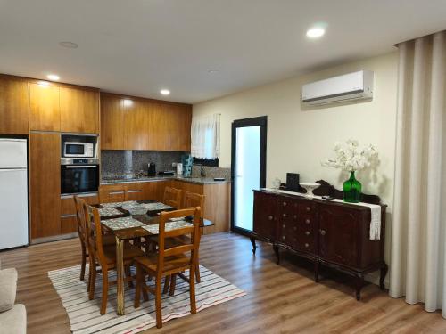 a kitchen with a table and chairs in a room at Casa Valinhas in São Jorge