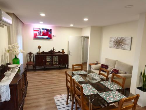 a living room with a table and chairs and a couch at Casa Valinhas in São Jorge