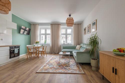 a living room with a couch and a table at Apartament Miętowy Kwidzyn in Kwidzyn