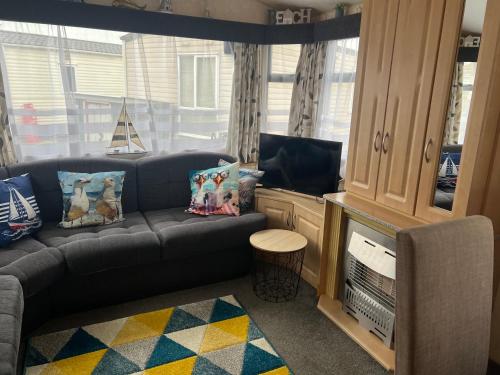 a living room with a couch and a tv at 51 A Static van on Smallgrove in Ingoldmells in Skegness