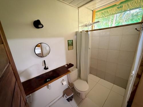 a bathroom with a toilet and a sink and a shower at Paroá Amazon Lodge in Manacapuru
