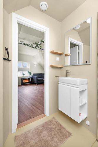 a bathroom with a sink and a mirror at Central Top Floor Apartment in Stavanger