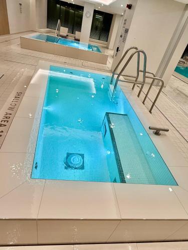 a large swimming pool in a building at Entire Luxe Condo in Downtown Toronto in Toronto
