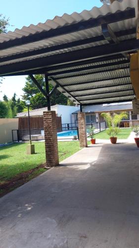 a patio with awning in front of a building at Apart Los Tilos 4 pax in Chascomús