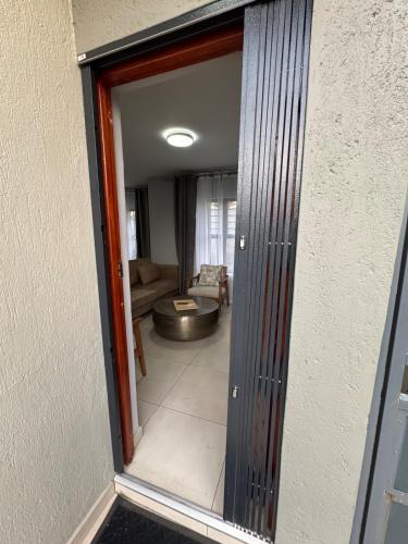 a view of a living room through a glass door at Kheniyas Haven in Nelspruit