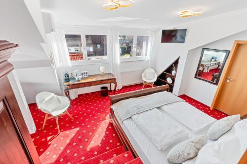 a bedroom with a bed and a desk and a chair at Scharnhäusle 15 - Guest room Ostfildern in Ostfildern