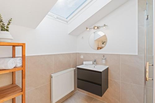 a bathroom with a sink and a mirror at Scharnhäusle 15 - Guest room Ostfildern in Ostfildern