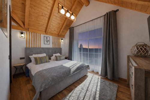 a bedroom with a bed and a large window at Căsuța Melimi cu piscină încălzită, ciubăr și saună in Râșca