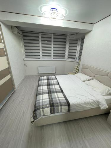 a bedroom with a large bed in a room at Apartament in Chişinău
