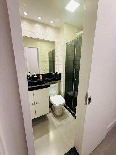 a bathroom with a toilet and a sink and a shower at Camboflat in Niterói