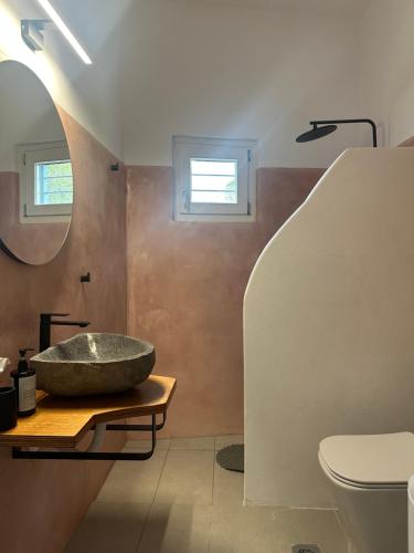 a bathroom with a large stone sink on a table at Leti Hydra in Hydra
