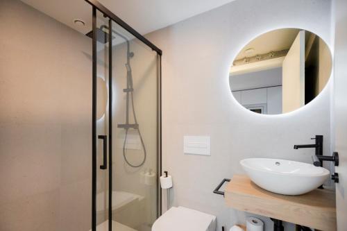 a bathroom with a shower and a sink and a mirror at ARENA byAstiblanco in Valencia
