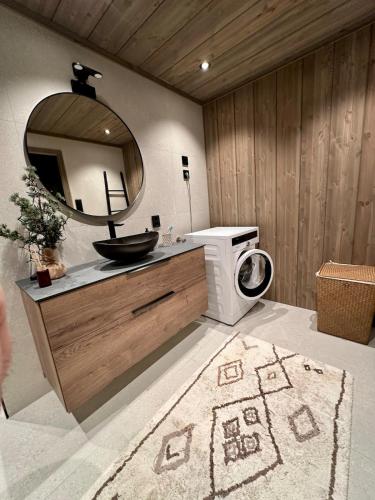 a bathroom with a sink and a mirror at Cabin with sea view in Moen