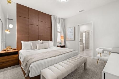 a bedroom with a large bed with a wooden headboard at 16159Coastal in Clermont