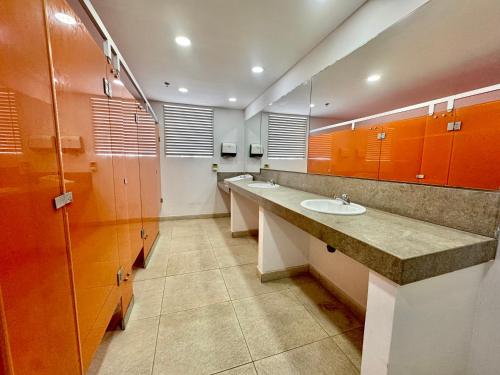 a bathroom with three sinks and orange cabinets at Apartamento Special For You in Cartagena de Indias