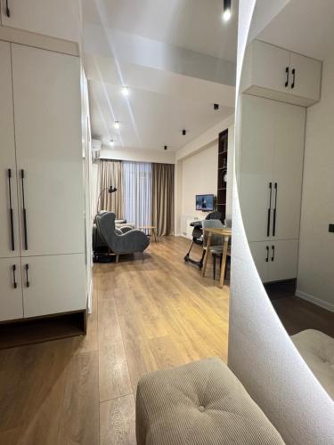 a living room with white cabinets and a couch at Fatmanis 98 in Tbilisi City