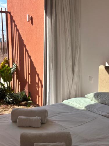 a bed with two towels on it in a bedroom at Terra Rossa Residences in Paralimni