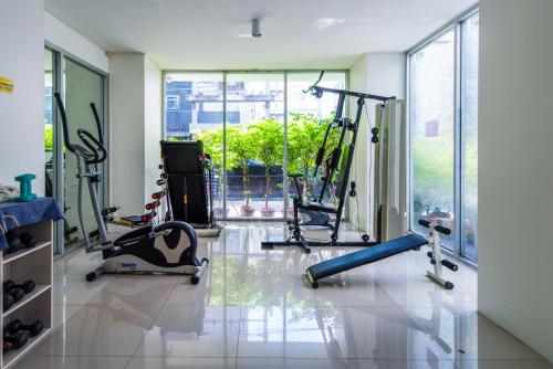 a gym with several treadmills and machines in a room at Amazing 2 bedrooms, near MRT Ratchada, Bangkok in Bangkok